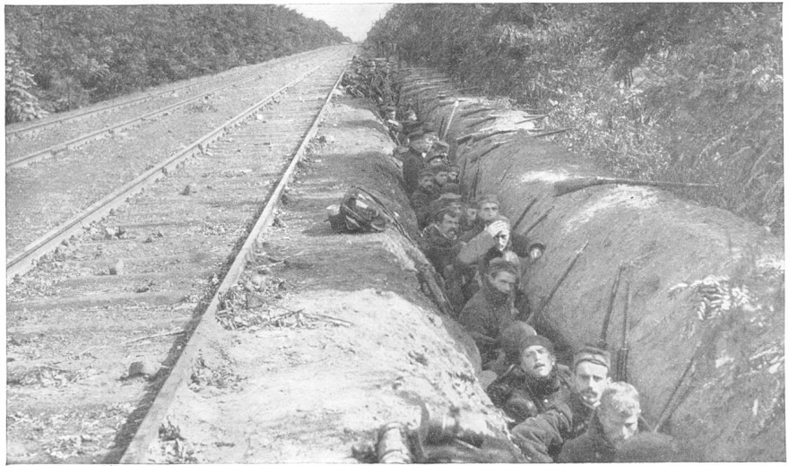 Allied troops digging in by the side of a railway